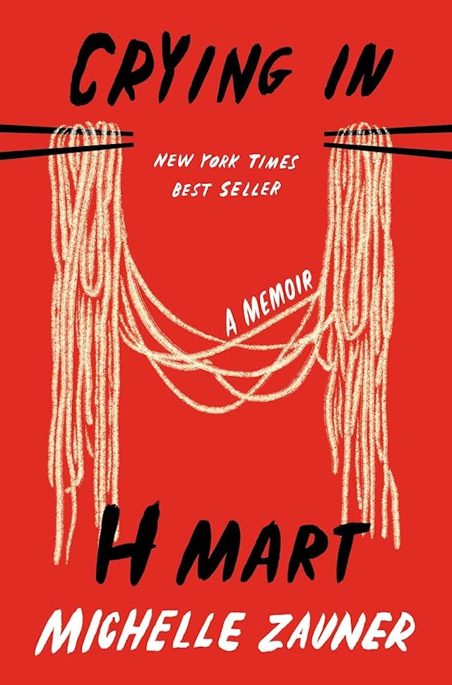 Crying In Hmart by Michelle Zauner book cover which has 2 sets of black chopstick ends at opposing sides of the book holding on to the same strands of yellow noodles on a vibrant red background